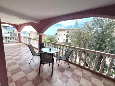 a patio with a table and chairs on a balcony at Sea view steps to Przno beach 2 Bedrooms Terrace Parking Villa Olive in Sveti Stefan
