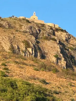 a building on top of a rocky mountain at Sea view steps to Przno beach 2 Bedrooms Terrace Parking Villa Olive in Sveti Stefan