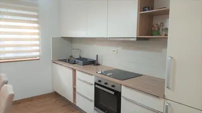 a kitchen with white cabinets and a sink and a refrigerator at Sea view steps to Przno beach 2 Bedrooms Terrace Parking Villa Olive in Sveti Stefan