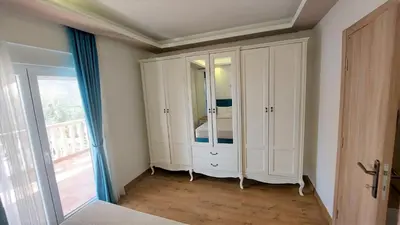 a bedroom with a white cabinet with a mirror at Sea view steps to Przno beach 2 Bedrooms Terrace Parking Villa Olive in Sveti Stefan