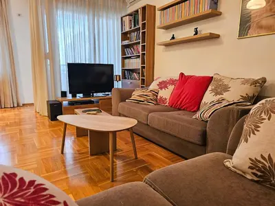 a living room with a couch and a tv at Luka's Blok 9 Apartment in Podgorica