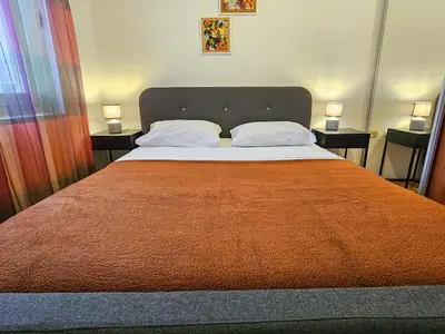 a bedroom with a large bed with two pillows at Luka's Blok 9 Apartment in Podgorica