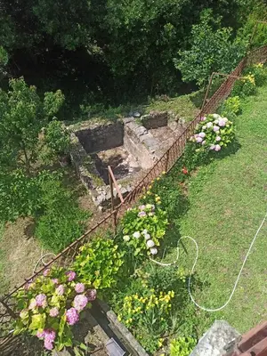 a garden with flowers and a fence at Apartmani Vučević in Sutomore