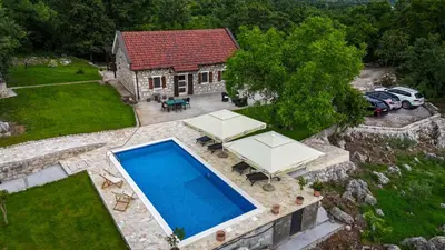 an aerial view of a house with a swimming pool at Holiday home Zlatna Glavica in Podgorica