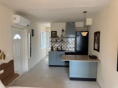 a kitchen with a island in the middle of a room at Steps to beach 3 Bedrooms 2 Bathrooms 2 Kitchens with a Terrace - 2 Parking spots - Sea View in Sveti Stefan