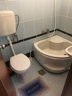 a bathroom with a toilet and a sink and a tub at Montenegrinbeautystar in Bar