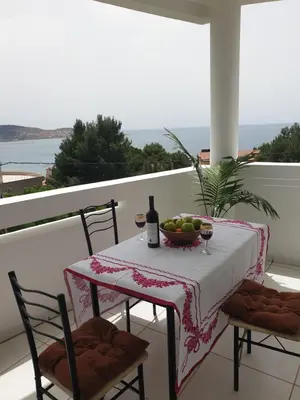 a table with a bowl of fruit on a balcony at Montenegrinbeautystar in Bar