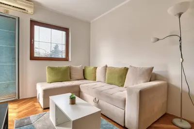 a living room with a couch and a table at M Apartment Budva in Budva