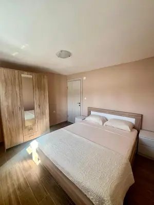 a bedroom with a large white bed in a room at Lakeside Harmony Apartment in Golubovci