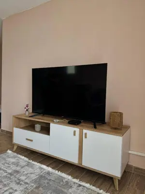 a flat screen tv on a white entertainment center at Lakeside Harmony Apartment in Golubovci