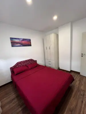 a bedroom with a large bed with a red blanket at Agatom in Budva