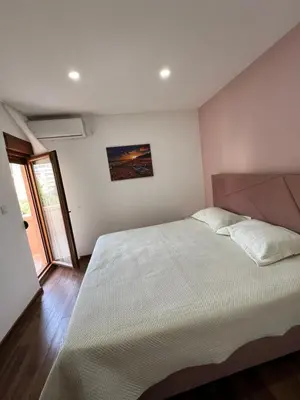 a bedroom with a large bed in a room at Agatom in Budva