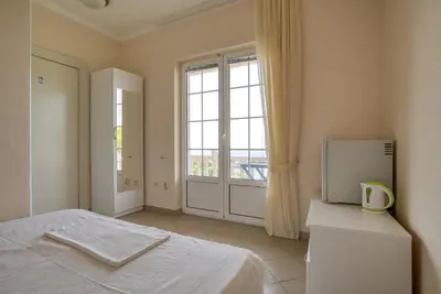 a bedroom with a bed and a large window at Apartmani Marina in Sutomore