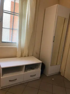 a dressing room with a white cabinet and a mirror at Apartmani Marina in Sutomore