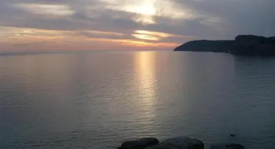 a sunset over a large body of water at Apartmani Marina in Sutomore