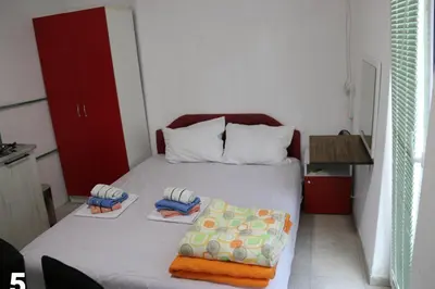a small bedroom with a bed with towels on it at Smještaj Milena Čanj in Čanj