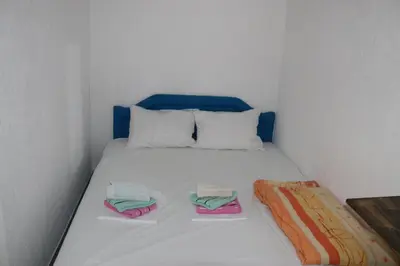 a white bed with two folded towels on it at Smještaj Milena Čanj in Čanj