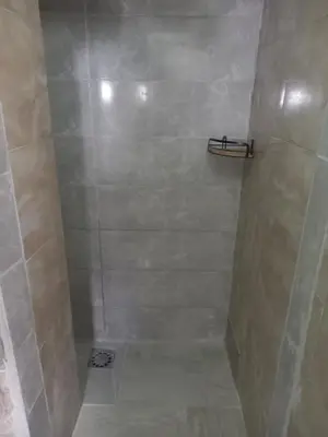 a bathroom with a shower with a tiled shower at Smještaj Milena Čanj in Čanj