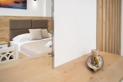 a bedroom with a bed and a mirror at GAVIA Apartments - Ulcinj in Ulcinj