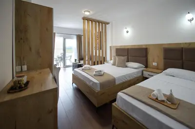 a hotel room with two beds and a balcony at GAVIA Apartments - Ulcinj in Ulcinj
