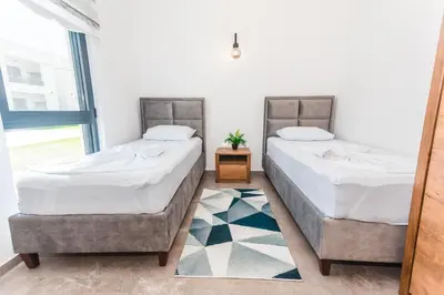 two beds sitting next to each other in a room at Bumax Apartments in Ulcinj