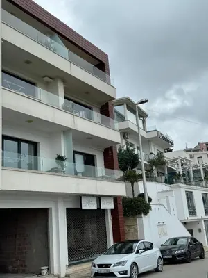 two cars parked in front of a building at BigBen Apartments in Ulcinj