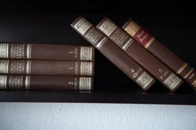 a group of books sitting on a shelf at BigBen Apartments in Ulcinj