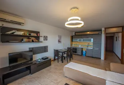 a living room with a bed and a dining room at BigBen Apartments in Ulcinj