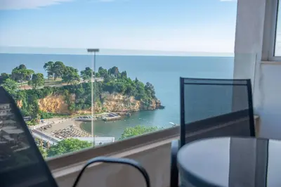 a room with a window with a view of the ocean at BigBen Apartments in Ulcinj
