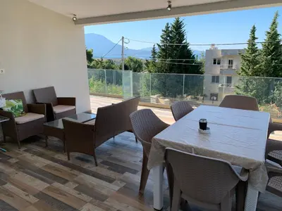 a room with a table and chairs and a large window at Villa DanDan Sutomore in Zagrađe