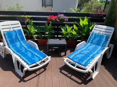 two lounge chairs and a table on a patio at Villa DanDan Sutomore in Zagrađe
