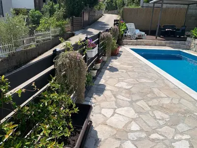a backyard with a swimming pool and potted plants at Villa DanDan Sutomore in Zagrađe