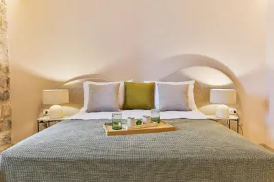 a bedroom with a large bed with a tray on it at Boutique hotel Ruzmarin SPA & Garden by Aycon in Budva