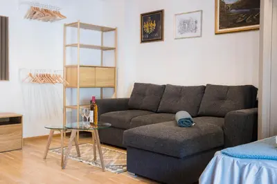 a living room with a couch and a table at Apartman Palma, Budva in Budva