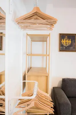 a room with a wooden shelf and a couch at Apartman Palma, Budva in Budva