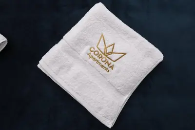 a white towel with the word woolworth on it at CORONA Apartments in Ulcinj