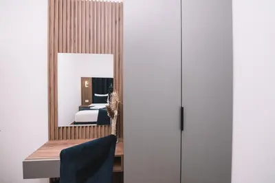 a bedroom with a mirror and a bed at CORONA Apartments in Ulcinj