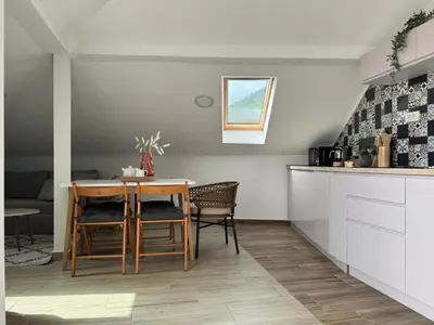 a kitchen and dining room with a table and chairs at SunJourney Apartment SEA view in Becici