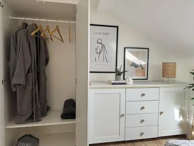 a bedroom with a white dresser and a closet at SunJourney Apartment SEA view in Becici