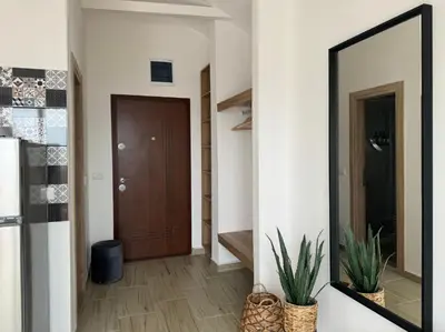 a mirror on a wall in a hallway at SunJourney Apartment SEA view in Becici