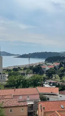 a view of a city with a body of water at SunJourney Apartment SEA view in Becici