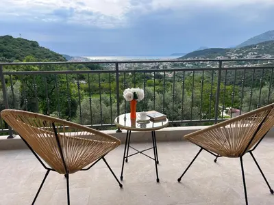 a balcony with two chairs and a table with a view at Family House Giardino Verde in Bar