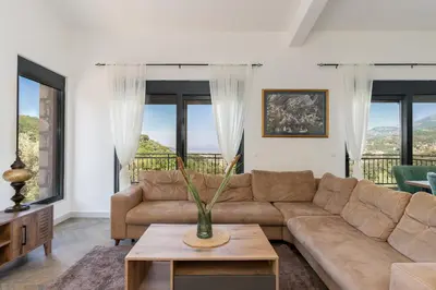 a living room with a couch and a table at Family House Giardino Verde in Bar