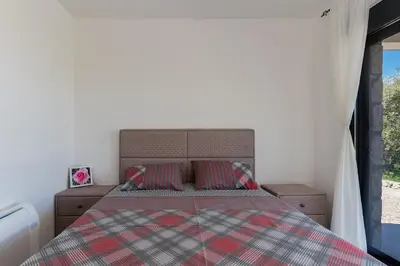 a bedroom with a bed and two pillows at Family House Giardino Verde in Bar