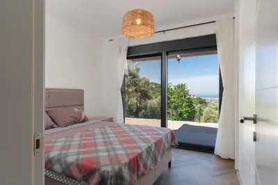 a bedroom with a bed and a large window at Family House Giardino Verde in Bar
