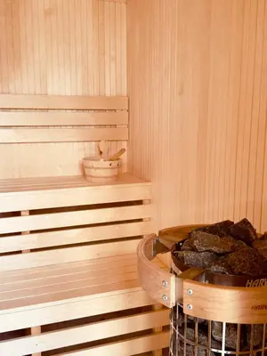 a sauna with a basket of rocks in it at Most Oliva Resort Budva in Budva