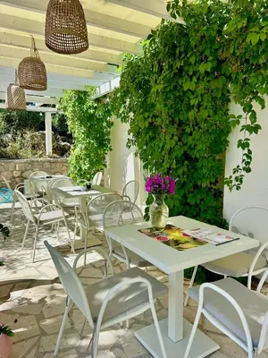 a group of tables and chairs on a patio at Most Oliva Resort Budva in Budva