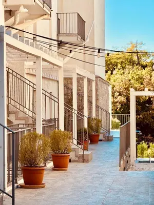 a building with stairs and potted plants on it at Most Oliva Resort Budva in Budva