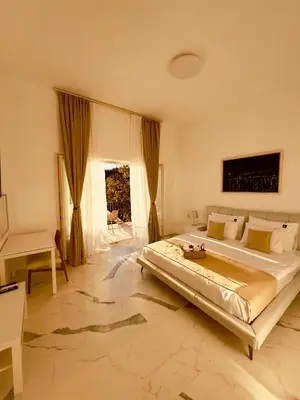 a large bedroom with a large bed and a desk at Most Oliva Resort Budva in Budva