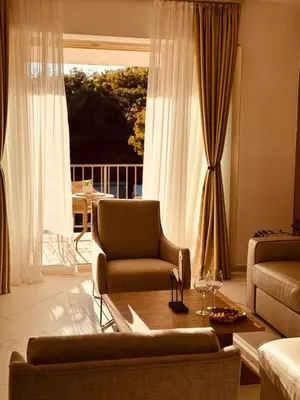 a living room with a couch and a chair at Most Oliva Resort Budva in Budva